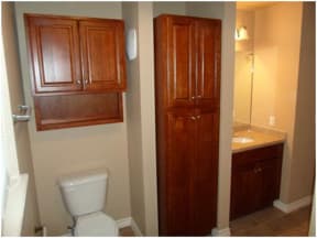 a bathroom with a toilet sink and a mirror
