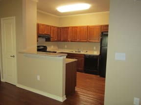 a kitchen with a stove a sink and a refrigerator