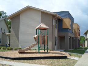 a playground with a slide in front of a building