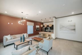 a living room filled with furniture and a large painting on the wall