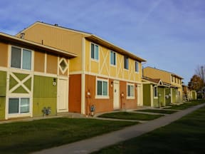 A row of houses with different colored front doors at Willow Grove Apartments, Clifton, Colorado.