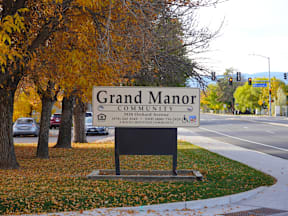 A sign for Grand Manor Community reads  at Grand Manor Apartments , Grand Junction, CO