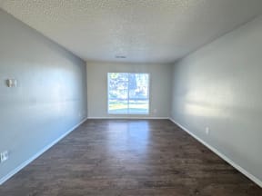 A room with wooden flooring and a window letting in light at Mountain Terrace Apartments, Westminster 80031.