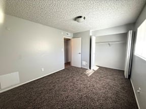 A room with carpeted floor and a doorway leading to another room at Mountain Terrace Apartments, Westminster CO