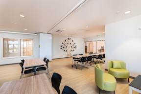 A conference room with a long table and chairs.