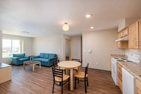 A kitchen with a table and chairs in the middle of the room.