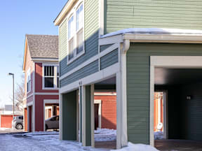 A green house with a red car parked in front at Meeker Commons Apartments, Colorado, 80631
