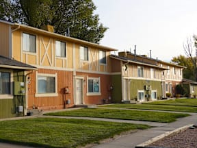 A row of houses with green lawns in front at Willow Grove Apartments, Clifton, 81520.