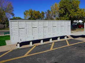 A row of mailboxes are lined up in a parking lot at Gateway Village Apartments, Fort Morgan, Colorado