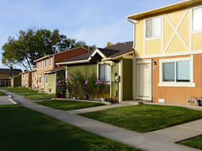 A row of houses with green lawns in front at Willow Grove Apartments, Clifton, 81520.