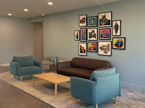 A living room with a blue couch, two chairs and a coffee table.