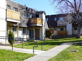 A row of apartment buildings with a walkway in front at Mountain Terrace Apartments, Colorado, 80031.