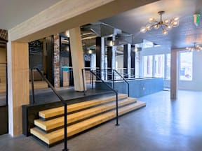 A staircase with wooden steps and black railings.