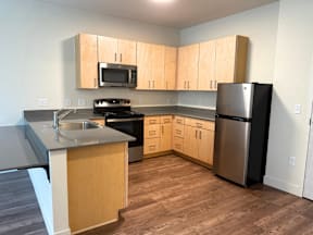A kitchen with wooden cabinets and stainless steel appliances.