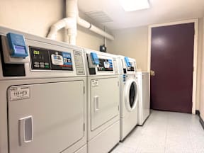 A row of washing machines in a laundromat.