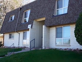 A house with a grey door and windows at Mountain Terrace Apartments, Westminster 80031.