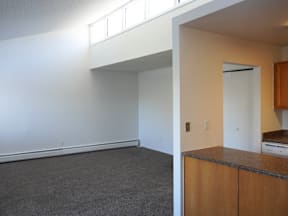 A room with a white wall and a brown cabinet at Garden Court Apartments, Colorado