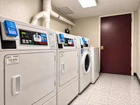A row of washing machines in a laundromat.