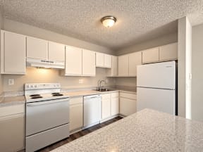 A kitchen with white appliances and cabinets.