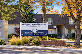 A sign for Mountain Terrace Apartments is displayed in front of a building t Mountain Terrace Apartments , Westminster, CO, 80031