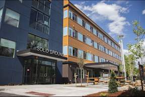 A modern building with the words "SOLID GROUND" on the front.