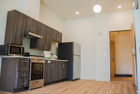A kitchen with dark wood cabinets and stainless steel appliances.