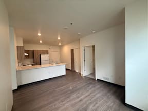A large, empty room with a counter and a sink.