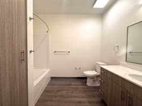 A bathroom with a toilet, sink, and bathtub.