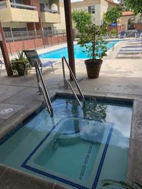 A small pool with a ladder in the middle of it.