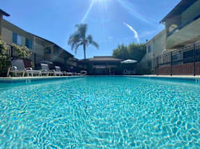A swimming pool with sunlight reflecting on the water.