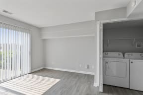 a bedroom with a washer and dryer in a 555 waverly unit
