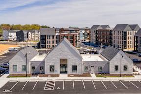 A parking lot with a white building in the middle.