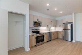 A kitchen with wooden cabinets and stainless steel appliances.
