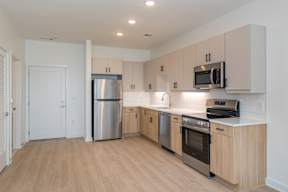 A kitchen with wooden cabinets and stainless steel appliances.
