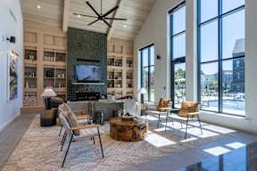 A modern living room with a fireplace and a television.