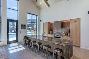 A kitchen with a bar area and a view of the city.