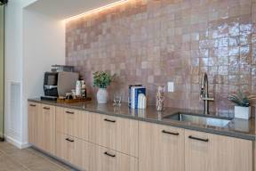 A kitchen with wooden cabinets and a tiled backsplash.