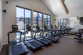 A gym with treadmills and exercise bikes.