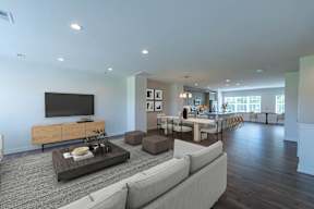 A modern living room with a white sofa and a wooden coffee table.