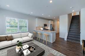 A modern living room with a staircase leading to the upper floor.