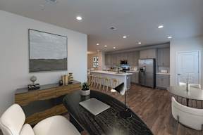 A modern kitchen with a dining table and chairs.
