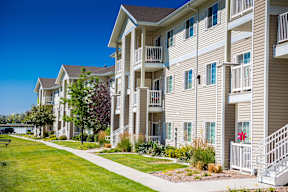 A row of apartment buildings with a clear blue sky above.