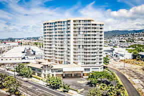 an aerial view of a tall building in the middle of a city