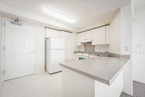 a kitchen with white cabinets and white appliances