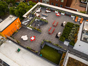 A rooftop patio with tables and chairs.