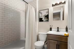 a bathroom with a toilet and a sink and a shower