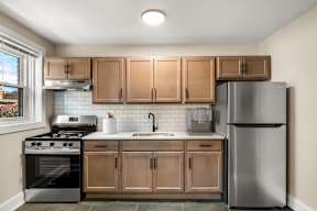 a kitchen with stainless steel appliances and wooden cabinets