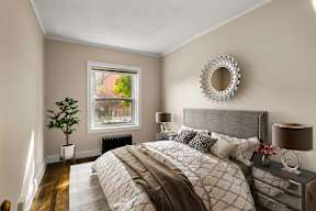 a bedroom with a large bed and a window