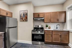 a kitchen with stainless steel appliances and wooden cabinets
