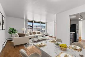 A modern living room with a dining table set for two.